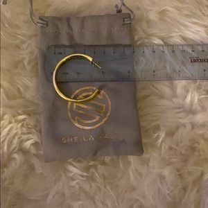 One (not the set) gold shiny hoop